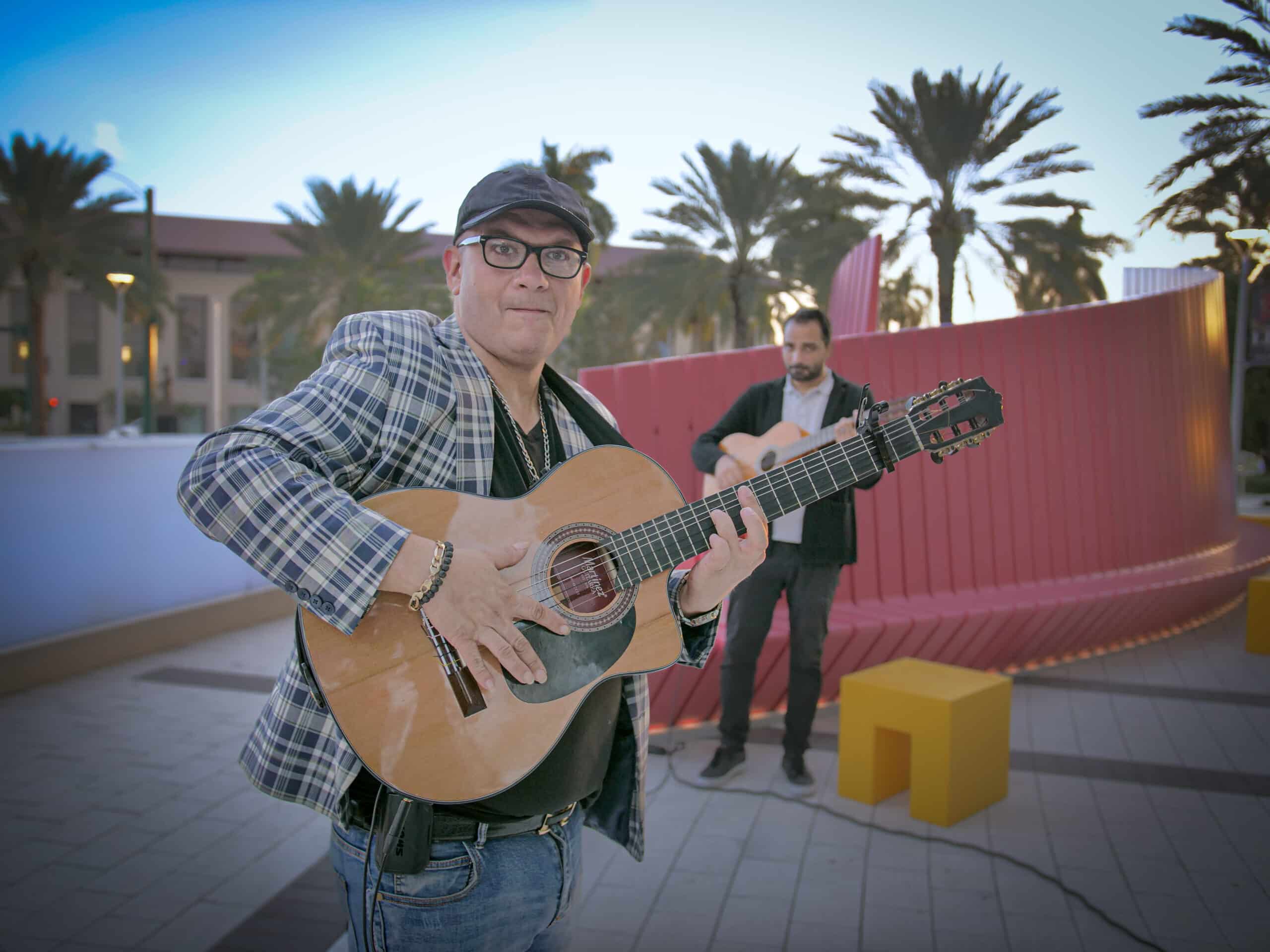Gyorgy Lakatos on plaza preforming with guitar