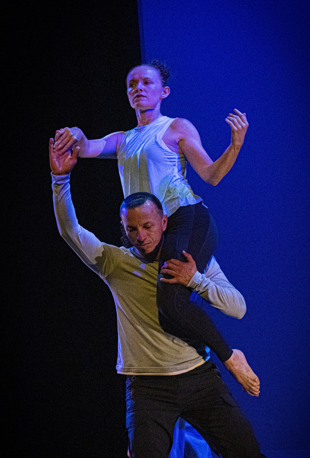 man hold up dancer on shoulder